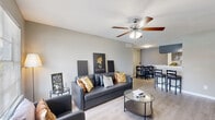 Located at 2909 Hayes Rd in Houston, TX, this efficiently designed one-bedroom, one-bathroom unit offers a well-organized single-floor layout. The open-concept living and dining area is bright and welcoming, featuring light wood-look flooring, neutral gray walls, and a ceiling fan with light fixture. A large window allows natural light to fill the space, creating an airy atmosphere. The living area flows seamlessly into the dining space, making it ideal for everyday living and entertaining.

The galley-style kitchen is thoughtfully appointed with gray cabinetry, marble-look countertops, black appliances including a range and refrigerator, and a stainless steel sink. Ample cabinet storage lines both sides of the kitchen, maximizing functionality within the compact layout.

The bedroom offers a comfortable, private retreat with plush carpeting, a ceiling fan, and a window with outdoor views. A dedicated closet provides convenient storage. The full bathroom features a clean, white tiled tub and shower combination with a patterned curtain and light wood-look flooring.

Throughout the unit, consistent neutral tones and modern finishes create a cohesive and practical living environment well-suited for those seeking comfortable urban living in the Houston area.