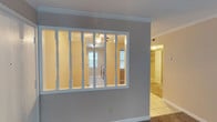 This single-floor residence offers a practical and comfortable layout with a mix of flooring finishes and thoughtful architectural details throughout. A standout feature of the living area is the decorative white spindle-rail partition wall, which visually separates spaces while maintaining an open, airy feel between rooms. Crown molding runs throughout the home, adding a refined touch to the neutral-toned walls.

The living and bedroom areas are finished with wall-to-wall carpet, providing warmth underfoot, while the entryway and kitchen feature light-toned ceramic tile flooring. The kitchen is well-appointed with rich, dark wood cabinetry offering generous upper and lower storage, a double-basin stainless steel sink, light countertops, a window that brings in natural light, and a dishwasher.

The bedrooms are spacious and include ample closet space, with at least one bedroom featuring a dedicated walk-in or reach-in closet. The bathroom is equipped with a full soaking tub and shower combination with clean white surround panels. Ceiling fans, HVAC vents, and textured ceilings are present throughout, contributing to a functional and well-maintained living environment. The overall ambiance is neutral, clean, and move-in ready.