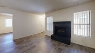 This single-story, 3-bedroom, 1-bathroom unit in Mesa, Arizona offers a practical and comfortable layout across a well-utilized floor plan. Wood-look flooring runs throughout the home, providing a cohesive and easy-to-maintain surface in every room. The living room serves as a welcoming centerpiece, highlighted by a classic dark brick fireplace and vertical blinds that allow natural light to filter in. Textured ceilings are present throughout the unit, adding a traditional aesthetic to the space. The kitchen is well-equipped with warm oak cabinetry, ample upper and lower storage, a double sink, white appliances including a range and dishwasher, and a ceiling fan—offering a functional galley-style layout that connects efficiently to the rest of the living area. A dedicated utility room and separate laundry area add convenience to daily living. The three bedrooms are each fitted with ceiling fans and closet access, with the spacious primary bedroom offering generous room for furnishings. The shared full bathroom features a clean tub/shower combo. A dedicated closet provides additional storage. The single-story layout ensures easy accessibility throughout the entire unit.