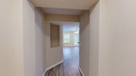 Located at 2015 Alexander Blvd in Murfreesboro, TN, this two-story home offers a well-organized layout across two floors, featuring three bedrooms, three bathrooms, and a dedicated closet. The main level hosts the combined kitchen and living area, where light-toned luxury vinyl plank flooring runs throughout, complemented by warm beige walls and ceiling fans that enhance airflow and comfort. The living room is generously proportioned, featuring multiple windows that invite abundant natural light and provide views of the surrounding greenery, along with a glass-panel door that opens to a rear patio area. The kitchen is equipped with warm wood cabinetry, dark countertops, and black appliances including a refrigerator, range, and built-in microwave, alongside a bright window overlooking the outdoors. Upstairs, the three bedrooms are finished with soft wall-to-wall carpet and feature vaulted or standard ceilings depending on the room, ceiling fans, and windows that frame outdoor views. The primary bedroom is notably spacious, offering ample room for furnishings. All three bathrooms include tub-shower combinations with clean white surrounds and chrome fixtures. Multiple hallways connect the spaces efficiently across both floors, making this home functional and easy to navigate throughout.