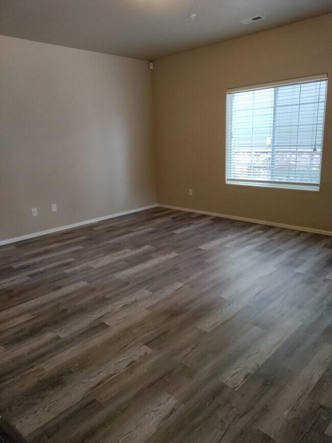 Living room with wood vinyl plank floor - 3070 Harpy Grove