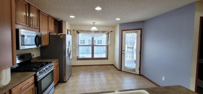 Kitchen window and deck entrance - 15205 French Dr N