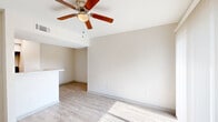 Located in Houston, TX, this one-bedroom, one-bathroom unit offers a thoughtfully designed single-floor layout that maximizes comfort and functionality. Light wood-style flooring flows throughout the entire space, contributing to a clean, airy aesthetic. The open living area is bathed in natural light courtesy of a large sliding glass door fitted with vertical blinds, and is equipped with a ceiling fan with built-in lighting. The layout connects seamlessly to a galley-style kitchen featuring crisp white shaker cabinetry, marble-look countertops, a double-basin sink, and stainless steel appliances including a refrigerator and range. A convenient pass-through counter opens the kitchen toward the living area, enhancing the sense of openness. The bedroom is a comfortable, well-lit space with a ceiling fan, a natural light-admitting window with blinds, and access to both a walk-in closet with built-in shelving and a standard double-door closet. The bathroom offers a clean, bright atmosphere with a white vanity, marble-look countertop, under-sink cabinetry, and a well-lit mirror with overhead lighting. Throughout the unit, neutral wall tones and consistent flooring create a cohesive and welcoming ambiance.