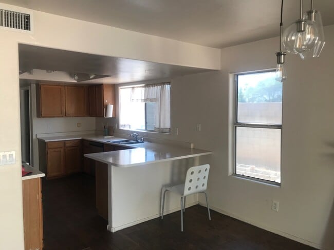 large kitchen with a lot of countertop space and a small bar extension - 17406 N 13th St