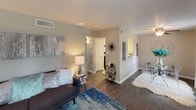 Located at 6433 S. Staples St in Corpus Christi, Texas, this well-appointed single-floor residence offers a thoughtfully designed layout that balances comfort and modern style. The entry foyer welcomes visitors with natural light streaming through flanking windows, setting a bright and inviting tone throughout.

The open-concept living area features rich wood-look flooring, neutral warm-gray walls, and a seamless flow between the sitting and dining spaces. A pass-through opening connects the living area to the kitchen, enhancing the sense of openness. The kitchen is outfitted with white cabinetry, granite-style countertops, track lighting, and black appliances, offering both functionality and clean aesthetic appeal.

The two bedrooms are generously proportioned, each featuring ceiling fans, wood-look flooring, and ample natural light. One bedroom includes a large sliding window with vertical blinds, while the other is appointed with mirrored nightstands and warm ambient lighting, creating a restful retreat.

The bathroom features a granite-topped vanity with a large mirror and well-lit fixture, alongside a separate shower area accessible through a hallway. Textured walls and coordinated finishes give the bath a polished, cohesive look. Throughout, the space is unified by consistent flooring, neutral tones, and contemporary detailing.