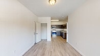 Located at 1900 Poplar St in Forest Grove, Oregon, this single-floor 2-bedroom, 2-bathroom unit offers a thoughtfully designed layout with modern finishes throughout. The open kitchen is a standout feature, outfitted with dark wood cabinetry, granite-style countertops, and a full suite of stainless steel appliances including a refrigerator, electric range, microwave, and dishwasher. Light wood-style flooring runs through the kitchen and living areas, creating a clean, contemporary feel. The primary bedroom provides a comfortable retreat with a dedicated closet, while both bedrooms feature plush carpeting and windows with blinds that allow natural light and views of the surrounding greenery. The bathrooms echo the kitchen's aesthetic with matching dark wood vanities, granite-style countertops, large mirrors, and wood-look flooring. A connecting hallway with an additional vanity area adds practicality to the layout. The unit also includes a closet for extra storage. The overall design is bright and neutral, with white walls and clean lines that give the space a fresh, move-in-ready appeal suited for comfortable everyday living.