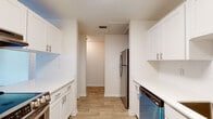 Located at 804 Fairmaiden Ln in Brandon, Florida, this single-story home offers a bright and functional layout with a clean, neutral palette throughout. The kitchen is a standout feature, outfitted with crisp white shaker-style cabinetry, brushed nickel hardware, light quartz countertops, and a full suite of stainless steel appliances including a refrigerator, dishwasher, and range. Wood-look tile flooring runs through the kitchen, complementing the white subway tile backsplash for a modern, cohesive finish. The open living and dining area is generously proportioned, with plush wall-to-wall carpeting, a textured ceiling, ceiling fans with integrated lighting, and a large sliding glass door dressed with vertical blinds that floods the space with natural light. Additional bedrooms are comfortably sized, each featuring soft carpeting, textured ceilings, and ceiling fans. The bathroom is well-appointed with white cabinetry, quartz countertops, brushed nickel fixtures, and a tiled shower-tub combination. Throughout the home, a consistent warm neutral color scheme and practical finishes create a welcoming and move-in-ready environment.