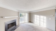 Located at 3761 Cape Landing Cir in Myrtle Beach, SC, this single-story residence offers a well-organized layout with comfortable living spaces throughout. The living room serves as the heart of the home, featuring a classic wood-burning fireplace with a simple mantel and neutral carpeting underfoot. A set of sliding glass doors floods the space with abundant natural light and opens to an outdoor balcony, where views of the surrounding area can be enjoyed. The textured ceiling and crown molding add a finished look to the room.

The galley-style kitchen is efficiently designed with white cabinetry, dark countertops, light wood-look flooring, and black appliances including a range and refrigerator. A double-basin sink and ample cabinet storage make this kitchen highly functional.

The bedrooms are carpeted and offer a calm, neutral palette. At least one bedroom includes a walk-in closet with wire shelving, providing organized storage. Additional closets are found throughout the home to accommodate storage needs.

The bathroom features a full tub-shower combination with clean white surroundings, light wood-look flooring, and a vanity with matching dark countertops, maintaining a consistent design aesthetic throughout the home.