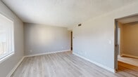 Located at 6374 Busch Blvd in Columbus, Ohio, this single-floor, 2-bedroom, 1-bathroom residence offers a practical and well-appointed layout across a compact, efficiently designed footprint. The living room serves as the welcoming centerpiece of the home, featuring light-toned luxury vinyl plank flooring, neutral gray walls, a textured ceiling, and a front-facing window that brings in natural light. The kitchen is a standout feature, showcasing dark charcoal shaker-style cabinetry paired with crisp white countertops, a stainless steel sink, and black appliances including a refrigerator and range, all set atop matching light LVP flooring. The spacious primary bedroom offers plush carpeting, a textured ceiling, and access to a dedicated closet with built-in shelving rods for organized storage. The second bedroom continues the carpeted flooring and neutral palette, also featuring a window for natural light. The full bathroom is clean and functional, equipped with a soaking tub and shower combination, a white vanity with countertop, a framed mirror, and matte black fixtures and hardware. Throughout the home, consistent neutral tones and updated finishes create a cohesive and move-in-ready atmosphere.