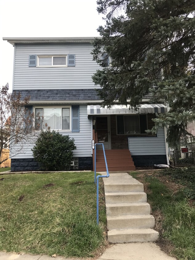 Porch with front yard and two parking spots located in the front of the house. - 108 Dinsmore Ave