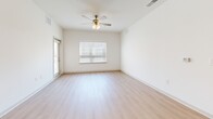 Located at 1070 Bolton Rd, Unit 4104 in Atlanta, GA, this 2-bedroom, 3-bathroom residence offers a well-designed single-floor layout with a bright, modern aesthetic. The open-concept kitchen and living area serves as the heart of the unit, featuring white upper cabinetry, gray lower cabinets, granite countertops, a peninsula island with pendant lighting, and a full suite of stainless steel appliances. Light wood-style flooring flows throughout the main living space, complementing the clean, neutral color palette. The living area is illuminated by natural light from large windows and finished with a ceiling fan. Both bedrooms are comfortably sized, carpeted, and equipped with ceiling fans and windows offering outdoor views. The primary bedroom includes access to a walk-in closet fitted with wire shelving systems for organized storage. The bathrooms are finished with granite-topped vanities, gray cabinetry, and tub-shower combinations with built-in shelving. Additional closet space provides further storage convenience. The overall design is cohesive and contemporary, with a light, airy ambiance carried consistently throughout each room.