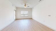 Located at 1070 Bolton Rd, Unit 4104 in Atlanta, GA, this 2-bedroom, 3-bathroom residence offers a well-designed single-floor layout with a bright, modern aesthetic. The open-concept kitchen and living area serves as the heart of the unit, featuring white upper cabinetry, gray lower cabinets, granite countertops, a peninsula island with pendant lighting, and a full suite of stainless steel appliances. Light wood-style flooring flows throughout the main living space, complementing the clean, neutral color palette. The living area is illuminated by natural light from large windows and finished with a ceiling fan. Both bedrooms are comfortably sized, carpeted, and equipped with ceiling fans and windows offering outdoor views. The primary bedroom includes access to a walk-in closet fitted with wire shelving systems for organized storage. The bathrooms are finished with granite-topped vanities, gray cabinetry, and tub-shower combinations with built-in shelving. Additional closet space provides further storage convenience. The overall design is cohesive and contemporary, with a light, airy ambiance carried consistently throughout each room.
