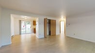 Located on NE Skyview Drive in Pullman, Washington, this single-story, 3-bedroom, 1-bathroom unit offers a practical and well-organized layout across a compact but efficiently utilized floor plan. Light wood-style flooring runs throughout, creating a cohesive and bright aesthetic in every room.

The main living area is open and functional, featuring a sliding glass door that fills the space with natural light and provides views of the outdoors. A centrally positioned closet with bifold doors adds convenient storage directly off the living area. A hallway connects the living space to the bedrooms and bathroom, maintaining a clear and logical flow throughout.

The galley-style kitchen features warm wood cabinetry, light countertops, and standard white appliances including a range and refrigerator, offering ample storage and workspace within a compact footprint.

The generously sized primary bedroom provides substantial space, while the two additional bedrooms are bright and comfortable, each equipped with windows that bring in natural light and baseboard heating. Closets are present in the bedrooms, providing practical storage solutions.

The bathroom includes a tub-shower combination with large-format marble-style tile surround, a vanity with a wood cabinet, and light flooring, presenting a clean and updated finish.