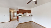Located at 3405 Logan Dr in Oshkosh, Wisconsin, this single-floor, 3-bedroom, 1-bathroom home offers a well-organized and functional layout. The open-concept kitchen and living area serves as the heart of the home, with warm hardwood-style flooring underfoot and a ceiling fan overhead. The kitchen is equipped with rich wood cabinetry, stainless steel appliances including a refrigerator and range, light countertops, and a peninsula that provides additional prep space and separates it from the living area. Natural light filters in throughout, and the living room features a sliding glass door that opens to an outdoor balcony, extending the living space and offering pleasant outdoor views. The three bedrooms are carpeted and feature wood-tone doors, with one bedroom including a double-door closet for ample storage. Additional closet space is available throughout the home. The bathroom is finished with tile flooring, a full tub-shower combination, and wood-accented vanity cabinetry. Clean white walls and consistent warm wood trim details lend a cohesive feel throughout the home, creating a comfortable and move-in ready living environment.
