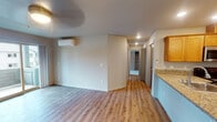 Located at 242 SW Cherry Park Rd in Troutdale, Oregon, this single-floor residence offers a thoughtfully designed layout with a clean, modern aesthetic throughout. The open-concept living and dining area features light wood-style vinyl plank flooring, recessed lighting, and a wall-mounted mini-split HVAC unit for year-round comfort. Sliding glass doors lead to a private balcony, filling the space with natural light and providing views of the surrounding neighborhood.

The kitchen is well-equipped with warm-toned wood cabinetry, granite countertops, a breakfast bar peninsula, stainless steel appliances including a refrigerator, range, and microwave, and recessed ceiling lighting. The adjacent living area flows seamlessly, creating an inviting and functional common space.

The bedrooms are carpeted and comfortably sized, each featuring windows that bring in natural light and offer views of the neighboring buildings and greenery. The two bathrooms are finished with hardwood-style flooring, granite-topped vanities with wood cabinetry, and large mirrors. One bathroom includes a walk-in shower with glass doors, while the other features a full soaking tub with shower. Together, these spaces create a comfortable, move-in-ready home in the Troutdale community.