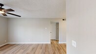 Located at 1764 N Leverett Ave in Fayetteville, Arkansas, this one-bedroom, one-bathroom unit offers a well-organized, single-floor layout designed for comfortable everyday living. Light-toned luxury vinyl plank flooring runs throughout the space, creating a cohesive and easy-to-maintain foundation in every room.

The combined kitchen and living area forms the heart of the unit. The kitchen features warm wood cabinetry, a stainless steel refrigerator, a dishwasher, a single-basin sink, and a flush-mounted overhead light. The living area is bright and open, highlighted by a ceiling fan and a set of French doors that invite natural light and provide outdoor access.

A connecting hallway leads to the spacious primary bedroom, which is generously sized and includes a ceiling fan, a window with natural light, and convenient access to multiple closets — three in total throughout the unit. The textured ceilings add a classic touch to the bedroom and living spaces.

The bathroom is clean and functional, featuring a tiled tub-and-shower surround with a built-in niche shelf. Neutral gray-beige tones carry throughout the unit, lending a calm, move-in-ready aesthetic. The layout also includes a dedicated hallway connecting all rooms efficiently.