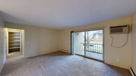 This one-bedroom, one-bathroom unit in Madison Heights, Michigan, offers a practical and comfortable layout across a single floor. The living room serves as the central gathering space, featuring neutral carpet flooring, warm beige walls, and a sliding glass door that opens onto a private balcony with views of the surrounding neighborhood. Baseboard heating runs along the perimeter, and a wall-mounted air conditioning unit provides year-round climate control.

The galley-style kitchen is efficiently designed with warm oak cabinetry, granite-patterned countertops, and tile flooring. It includes a white electric range, refrigerator, and a double-basin sink, with ample upper and lower cabinet storage for everyday needs.

The bedroom is a well-proportioned, carpeted space filled with natural light from a large window dressed with sheer curtains. Baseboard heating continues here, and the room connects to a hallway that provides access to two closets, offering generous storage for a space of this size.

The bathroom features tile flooring, a full bathtub and shower combination, a toilet, and a towel bar, all set within a clean, neutral palette. A connecting hallway ties all rooms together, creating a logical and easy-to-navigate flow throughout the unit.