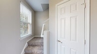 Located at 508 Pride Avenue in Herndon, Virginia, this three-bedroom, two-bathroom home spans three floors, offering a well-organized and functional layout. The entry level provides a welcoming entrance with access to the upper floors via carpeted staircases. The main living floor serves as the heart of the home, featuring an open-concept living and dining area adorned with crown molding, a ceiling fan, and a fireplace with a tile surround — complemented by light-toned hardwood-style flooring throughout. Sliding glass doors lead to an outdoor deck, bringing in natural light and outdoor access. The kitchen is equipped with white shaker cabinetry, dark countertops, stainless steel appliances including a gas range, microwave, and refrigerator, along with a peninsula island ideal for casual dining. A pantry provides additional storage. The upper floor houses all three bedrooms, including a generously sized primary bedroom with multiple windows offering neighborhood views. The bedrooms feature hardwood-style flooring and ample closet space. Two full bathrooms serve the home, each finished with white vanities and tub-shower combinations. The neutral color palette and clean finishes throughout give the home a bright, move-in-ready feel.