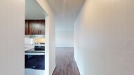 This 1050 square foot single-story apartment offers a harmonious blend of comfort and contemporary design. The space features three bedrooms, including a generous 180 square foot primary bedroom, and two well-appointed bathrooms. The heart of the home is a modern kitchen, showcasing rich cherry-wood cabinetry, granite countertops, and stainless steel appliances. The open-concept layout seamlessly integrates the kitchen with the living area, creating an inviting space for both relaxation and entertainment. Throughout the apartment, warm wood flooring adds a touch of elegance and continuity. Large windows in the bedrooms and living areas flood the space with natural light, while also providing pleasant outdoor views. The bathrooms are equipped with modern fixtures and vanities that complement the overall design aesthetic. Additional features include a ceiling fan for improved air circulation and built-in storage solutions. With its thoughtful layout and quality finishes, this apartment in Summit West (Unit 35D - C2) offers a comfortable and stylish living environment.