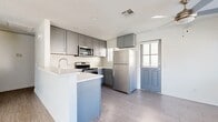Located in San Bernardino, CA, this single-story, 2-bedroom, 2-bathroom home offers a clean, modern aesthetic throughout. The open-concept kitchen and living room serve as the heart of the home, anchored by a well-appointed kitchen featuring gray shaker-style cabinetry, a patterned tile backsplash, light quartz countertops, a peninsula with a built-in sink, and a full suite of stainless steel appliances including a refrigerator, range, microwave, and dishwasher. Light wood-look flooring runs throughout, lending a cohesive and contemporary feel. The living room is bright and airy, with a sliding glass door that fills the space with natural light and opens to an outdoor area with scenic mountain views. Both bedrooms are well-sized, featuring the same light flooring, neutral walls, and windows with blinds. The primary bedroom offers a comfortable footprint with its own dedicated closet. Each bathroom is finished with gray vanity cabinetry, stone-look countertops, and chrome fixtures; one bathroom includes a tub-shower combination. A dedicated laundry room houses a full-size GE washer and dryer with overhead shelving, adding everyday convenience to this thoughtfully designed home.