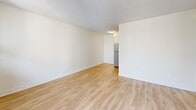 This well-appointed one-bedroom, one-bathroom unit at 43 Forest Ave in Hamilton, Ontario spans two floors, offering a thoughtfully organized layout with generous overall square footage. The main floor accommodates the primary living areas, while the upper floor provides additional functional space. Light hardwood-style flooring flows throughout, complementing the clean, neutral palette of white walls and textured ceilings.

The entrance opens into a bright hallway that leads to the main living and dining area, which benefits from large floor-to-ceiling sliding glass windows and direct access to a private balcony with open city views. The galley-style kitchen is efficiently designed, featuring white cabinetry, dark countertops, subway tile backsplash, and a full suite of stainless steel appliances including a refrigerator, stove, and over-the-range microwave.

The bedroom is comfortably sized, featuring a sliding-door closet, a large window with natural light, and baseboard heating. A second closet provides additional storage. The bathroom is finished with white subway tile surrounding a full soaker tub and shower, a white vanity, and neutral tile flooring. The unit includes two closets for practical storage throughout.