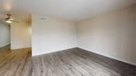 Located at 4000 58th St N in Kenneth City, Florida, this well-appointed 1-bedroom, 1-bathroom residence offers a thoughtfully designed single-floor layout. Wood-look luxury vinyl flooring runs throughout, lending a cohesive and contemporary feel to the entire space. The open-concept living and dining area is bright and airy, highlighted by a large sliding glass door that fills the room with natural light and provides direct access to a private balcony with outdoor views. The kitchen is outfitted with crisp white shaker-style cabinetry, ample upper and lower storage, light marble-look countertops, and a stainless sink — complemented by a full-size black refrigerator. A dedicated laundry nook with a stacked washer and dryer unit adds everyday convenience. The generously sized bedroom features a ceiling fan, a natural light window, and comfortable proportions, supported by three closets offering exceptional storage throughout the unit. The full bathroom includes a tub-shower combination with white tile surround, a vanity with marble-look countertop, and matching wood-look flooring. Hallways connect the spaces efficiently, completing this clean and functional floor plan.
