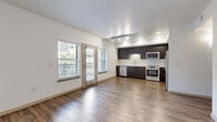Located at 3111 S St in Sacramento, CA, this well-appointed 3-bedroom, 2-bathroom residence offers a thoughtfully designed single-level layout. The open-concept living and kitchen area serves as the heart of the home, featuring rich wood-style plank flooring, track lighting, and multiple windows that flood the space with natural light. A glass door provides direct outdoor access, enhancing the bright and airy feel of the living area.

The kitchen is outfitted with dark espresso cabinetry extending to the ceiling for ample storage, crisp white quartz countertops, a classic subway tile backsplash, and a full suite of stainless steel appliances including a French door refrigerator, electric range, built-in microwave, and dishwasher.

Two hallways connect the living spaces to the three bedrooms and two bathrooms. The bedrooms feature plush carpeting and windows with views to the exterior, providing comfortable and well-lit retreats. The primary bedroom is a generous size with dedicated closet space. Both bathrooms are finished with wood-look tile flooring, soaking tub/shower combinations, built-in shelving, and dark vanity cabinetry with white countertops. The overall design maintains a clean, modern aesthetic with neutral tones throughout.