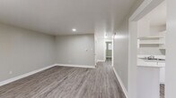 Located at 431 E Willamette Ave in Colorado Springs, Colorado, this single-story, 2-bedroom, 1-bathroom home offers a clean and modern interior with a cohesive neutral color palette throughout. The layout includes a living room, two bedrooms, a kitchen, and a full bathroom, making efficient use of the available floor space.

The living room is an open, welcoming area featuring updated luxury vinyl plank flooring in a warm gray tone and recessed lighting, creating a bright and functional gathering space. A window allows natural light to filter in, adding to the airy feel of the room.

Both bedrooms continue the LVP flooring and neutral gray walls, each equipped with a ceiling fan and light fixture. The primary bedroom is a comfortable size and includes a closet, while the second bedroom features a window with blinds that brings in additional natural light.

The kitchen is designed in a U-shaped layout with white cabinetry, open shelving, light countertops, and white appliances including a full-size refrigerator. The space is practical and well-organized. The bathroom is equipped with a full tub and shower combination with clean white tile surround. Consistent white trim and baseboards tie the entire home together, giving it a fresh, updated appearance.
