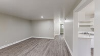 Located at 431 E Willamette Ave in Colorado Springs, Colorado, this single-story, 2-bedroom, 1-bathroom home offers a clean and modern interior with a cohesive neutral color palette throughout. The layout includes a living room, two bedrooms, a kitchen, and a full bathroom, making efficient use of the available floor space.

The living room is an open, welcoming area featuring updated luxury vinyl plank flooring in a warm gray tone and recessed lighting, creating a bright and functional gathering space. A window allows natural light to filter in, adding to the airy feel of the room.

Both bedrooms continue the LVP flooring and neutral gray walls, each equipped with a ceiling fan and light fixture. The primary bedroom is a comfortable size and includes a closet, while the second bedroom features a window with blinds that brings in additional natural light.

The kitchen is designed in a U-shaped layout with white cabinetry, open shelving, light countertops, and white appliances including a full-size refrigerator. The space is practical and well-organized. The bathroom is equipped with a full tub and shower combination with clean white tile surround. Consistent white trim and baseboards tie the entire home together, giving it a fresh, updated appearance.
