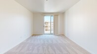 Located at 2020 4th Street in Berkeley, CA, this one-bedroom, one-bathroom residence offers a thoughtfully designed single-floor layout with a clean, modern aesthetic throughout. The open-concept kitchen is a standout feature, showcasing warm maple cabinetry, light countertops, and a full suite of stainless steel appliances including a range, microwave, dishwasher, and refrigerator. A peninsula with pendant lighting above separates the kitchen from the combined dining and living area, which features light hardwood flooring and flows naturally toward the balcony — ideal for letting in natural light and outdoor air. The bedroom is generously proportioned, fitted with soft carpeting and a sliding glass door that opens to its own outdoor access, as well as a window providing additional natural light. Five closets throughout the unit offer exceptional storage capacity. The bathroom is well-appointed with tile flooring, a wood-toned vanity, large mirror, and clean white finishes. A hallway connects the living spaces to the private quarters, providing a sensible layout. The overall ambiance is bright, neutral, and move-in ready, with consistent modern finishes throughout.
