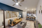 Located at 698 Basilica Bay Drive in Spring, TX, this 2-bedroom, 1-bathroom residence offers a thoughtfully designed single-level layout that maximizes every square foot. The living room features light wood-style flooring, a ceiling fan, and a striking bold navy accent wall with geometric detailing, creating a vibrant yet welcoming atmosphere. Natural light filters in through blinds and draped windows, enhancing the open feel of the space.

The kitchen is a standout feature, showcasing dark espresso cabinetry, quartz countertops, stainless steel appliances, and a peninsula island with bar seating — ideal for casual dining or entertaining. A built-in desk nook nestled beside the kitchen provides a dedicated workspace, framed by the same bold navy accent wall.

The primary bedroom offers a comfortable retreat with plush carpeting, a ceiling fan, natural light from a large window, and direct access to the full bathroom. The second bedroom is equally well-sized and functional. The bathroom is finished with tile surround, a soaking tub with shower, wood-toned vanity cabinetry, and granite-style countertops. A dedicated closet rounds out the unit's practical storage offerings.