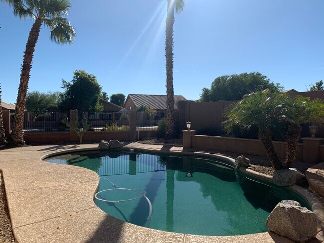 Spacious 4-bedroom, 2-bath home with soaring ceilings, gourmet kitchen, and a heated self-cleaning p - 16426 N 152nd Ln