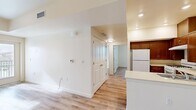 Located at 1335 W Luchessa Ave in Gilroy, CA, this single-floor residence offers a clean, modern layout with consistent light wood-style flooring throughout. The open-concept kitchen is well-appointed with rich warm-toned cabinetry, light countertops, a gas range, refrigerator, and a peninsula that provides both additional prep space and a natural divide from the living area. Recessed lighting and flush-mount fixtures illuminate the space effectively throughout. The living area is bright and open, benefiting from a glass door that leads to a private patio, allowing natural light to fill the room. Bedrooms are comfortably sized with large sliding closets and windows offering outdoor views of the surrounding landscape, including mountain scenery. The bathroom features a full tub and shower combination, a vanity with wood cabinetry and a mirror, and the same wood-style flooring found throughout the unit. A hallway connects the main living spaces to the private areas, with additional closet storage accessible along the way. The overall aesthetic is clean and neutral, with crisp white walls and trim creating a bright, welcoming ambiance throughout the entire residence.
