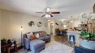 This charming 730 square foot apartment in Daytona Beach, Florida offers a perfect blend of comfort and style. The single-story layout comprises two bedrooms, two bathrooms, a kitchen, living room, and closet space. The primary bedroom, at 140 square feet, provides ample space for relaxation.

The living area is inviting, featuring a comfortable sectional sofa, stylish area rug, and ceiling fan. Large sliding glass doors flood the space with natural light and offer access to an outdoor patio. The modern kitchen boasts sleek appliances, white cabinetry, and a spacious granite countertop, ideal for meal preparation and casual dining.

Both bedrooms are well-appointed with plush carpeting, ceiling fans, and large windows. The bathrooms feature clean, white fixtures and contemporary finishes. Throughout the apartment, you'll find thoughtful decorative touches, including artwork, mirrors, and accent pieces that create a cohesive and inviting atmosphere.

The apartment's efficient design maximizes the use of space, making it feel larger than its 730 square feet. With its blend of functionality and style, this Daytona Beach apartment offers a comfortable living experience in a prime location.