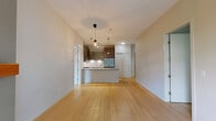 Located at 210 Salter St in New Westminster, BC, this well-appointed 2-bedroom, 2-bathroom residence offers a thoughtfully designed open-concept layout. Light hardwood flooring flows throughout the main living areas, enhancing the bright and airy atmosphere. The open kitchen is a standout feature, boasting rich dark wood cabinetry, stainless steel appliances including a gas range and French door refrigerator, a granite-topped island with an undermount sink, and stylish pendant lighting. The kitchen transitions seamlessly into a combined dining and living area, where large windows flood the space with natural light and a fireplace with a wood mantel serves as a focal point. A sliding door leads to the balcony, extending the living space outdoors. The primary bedroom is generously sized and supported by a well-organized walk-in closet with wire shelving. The second bedroom also features a large window with outdoor views. Both bathrooms are finished with granite countertops and dark wood vanities. Additional highlights include a versatile den, an in-unit laundry, and three closets providing ample storage throughout.