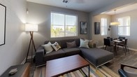 Located at 10001 E Dry Creek Rd in Englewood, Colorado, this single-floor residence at Rail at Inverness Apartment Homes offers a thoughtfully designed layout with contemporary finishes throughout. The living room serves as the central gathering space, featuring rich hardwood-style flooring, a ceiling fan, and large windows fitted with blinds that invite abundant natural light and views of the surrounding greenery. The kitchen is outfitted with dark espresso cabinetry, light countertops, stainless steel appliances including a dishwasher, range, and microwave, and durable wood-look flooring that ties the space together. Multiple bedrooms provide comfortable retreats, each carpeted and featuring large windows with blinds and curtains for privacy. The primary bedroom includes a walk-in closet with built-in shelving and rod storage, offering excellent organization potential. Both bathrooms feature dark vanity cabinetry, white countertops, wood-look flooring, large mirrors, and shower/tub combinations. Neutral gray tones are used consistently throughout the home, lending a cohesive, modern aesthetic. The overall ambiance is clean and contemporary, well-suited for comfortable everyday living in the heart of the Denver Tech Center corridor.