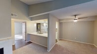 Located at 815 NE Green Oaks Blvd in Arlington, Texas, this single-floor unit offers a well-designed, open-concept layout that maximizes both function and flow. The living area is finished with plush carpeting and features a classic fireplace as a focal point, complemented by a ceiling fan and a sliding glass door that opens to a private patio, allowing natural light to fill the space. Neutral-toned walls throughout create a clean, cohesive aesthetic.

The kitchen is thoughtfully designed with a pass-through peninsula counter and sink that connects seamlessly to the living area. White cabinetry, a full suite of white appliances — including a refrigerator, electric range, built-in microwave, and dishwasher — and durable wood-style flooring give the kitchen a bright, practical character. An adjacent utility area provides additional convenience.

The bedrooms are carpeted and generously sized, each featuring ample closet space, including a large sliding-door closet in one room. Natural light filters in through blinds-covered windows. The bathroom is well-appointed with a white vanity, framed mirror, a bright vanity light bar, and a full tub-shower combination, all finished in neutral tones that contribute to the unit's overall clean and welcoming ambiance.