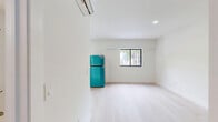 Located on SW 4th Street in Miami, FL 33130, this efficient single-floor unit makes smart use of its compact footprint. The interior features a clean, modern aesthetic with white walls and light hardwood-style flooring that runs consistently throughout the space, lending a bright and cohesive feel.

The kitchen is well-appointed with crisp white shaker-style cabinetry — both upper and lower — paired with light countertops. It comes fully equipped with a stainless steel range, an over-the-range microwave, and a bold turquoise refrigerator that adds a striking pop of color. A single-basin stainless steel sink completes the functional layout, offering everything needed for everyday meal preparation.

The bathroom is neatly designed with a white vanity with cabinet storage, a wall-mounted mirror, and a full-size soaking tub with an overhead shower. Brushed nickel fixtures and a clean white palette give the bathroom a tidy, polished appearance.

The main living area is open and uncluttered, featuring recessed lighting, a window that allows natural light to filter in, and a closet with bifold doors for storage. The minimalist design keeps the space feeling airy and adaptable to various furniture arrangements, making it a versatile and practical unit in the heart of Miami.