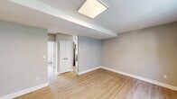 This well-appointed one-bedroom, one-bathroom unit at 465 Morris Ave in Elizabeth, NJ offers a thoughtfully designed single-floor layout. Light-toned luxury vinyl plank flooring runs throughout, lending a clean, cohesive feel to every room. The living room is bright and open, featuring large multi-pane windows that invite natural light and views of the surrounding greenery, complemented by a wall A/C unit and baseboard heating for year-round comfort. The kitchen is efficiently laid out with rich dark-toned cabinetry, white quartz countertops, a marble-style tile backsplash, and a full suite of stainless steel appliances including a gas range, over-the-range microwave, refrigerator, and dishwasher. A window above the sink adds natural light to the cooking space. The bedroom offers a comfortable footprint with a large window, baseboard heating, and the added convenience of two closets for generous storage. The bathroom is a standout feature, finished with floor-to-ceiling marble-look porcelain tile surrounding a tub-shower combination, paired with a sleek white vanity and modern chrome fixtures. Neutral gray walls throughout the unit create a calm, versatile backdrop, making this a practical and attractive space.