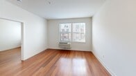 This well-appointed one-bedroom, one-bathroom residence at 103 S Wood Ave, Unit 303 in Linden, NJ offers a thoughtfully designed single-floor layout. Warm hardwood flooring flows consistently throughout the living areas and bedroom, creating a cohesive and inviting atmosphere.

The open-concept kitchen and living room area serves as the heart of the unit. The kitchen is equipped with rich dark espresso cabinetry, granite countertops, a decorative tile backsplash, and a full suite of black appliances including a range, over-the-range microwave, and refrigerator. A peninsula with a stainless steel sink and additional counter space provides a natural division between the kitchen and living area.

The bedroom is a comfortably sized, light-filled room featuring large windows that allow ample natural light, warm hardwood flooring, and a wall-mounted HVAC unit for personalized climate control.

The bathroom maintains the unit's consistent design language with dark cabinetry, a vanity with white countertop, light wood-look tile flooring, and conveniently placed grab bars for accessibility.

Throughout the unit, clean white walls, modern panel-style doors, and consistent finishes create a polished, move-in-ready environment well-suited for comfortable everyday living.