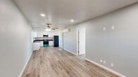 Located at 4040 E Dakota Ave in Fresno, CA, this efficiently designed 2-bedroom, 2-bathroom single-story unit offers a clean, modern aesthetic throughout. The open-concept layout seamlessly connects the kitchen and living area, creating a bright and functional shared space. Light wood-look flooring runs throughout the unit, complementing the soft gray walls and crisp white trim for a cohesive, contemporary feel. Ceiling fans provide added comfort in both the living area and bedrooms.

The kitchen is well-appointed with white shaker-style cabinetry, dark countertops, a stainless steel sink, and a full suite of stainless steel appliances including a refrigerator, range, and over-the-range microwave. Recessed lighting illuminates the space effectively.

Both bedrooms are comfortably sized, featuring light-filled windows with curtains, light wood flooring, ceiling fans, and wall-mounted mini-split HVAC units for individual climate control. Three closets are distributed throughout the unit for ample storage.

The bathrooms are a standout feature, showcasing elegant marble-style porcelain tile in the walk-in glass-enclosed shower, accented by a decorative mosaic tile border. The clean white vanity and chrome fixtures complete the polished, upscale bathroom design. This unit offers a thoughtfully updated living environment with quality finishes throughout.