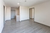 This single-floor unit in El Paso, Texas, presents a clean, contemporary design with thoughtfully selected finishes throughout. Light wood-look flooring runs continuously across the living and sleeping areas, contributing to a cohesive and bright aesthetic. Neutral wall tones complement the overall palette, creating an open and airy atmosphere.

The kitchen is efficiently designed with flat-front, warm wood-toned cabinetry extending from floor to ceiling, providing ample storage. A white subway tile backsplash adds a modern touch, while the countertops offer functional workspace. Stainless steel appliances include a refrigerator, dishwasher, and range hood, along with an integrated cooktop and sink. A pass-through counter connects the kitchen to the living area.

The living space is well-proportioned and receives natural light through large windows that frame views of surrounding trees and El Paso's characteristic rocky terrain. A wall-mounted HVAC unit provides climate control in the main living and sleeping areas.

The unit includes two bathrooms: one featuring a glass-enclosed walk-in shower with hexagonal tile flooring and a wood-toned vanity, and a second with a full soaking tub and shower combination, also finished with hexagonal tile flooring and brushed nickel fixtures.