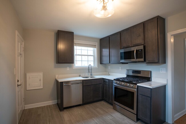 Kitchen features brand new stainless appliances with gas range, dishwasher, and quartz counter tops. - 5029 N Bay Ridge Ave