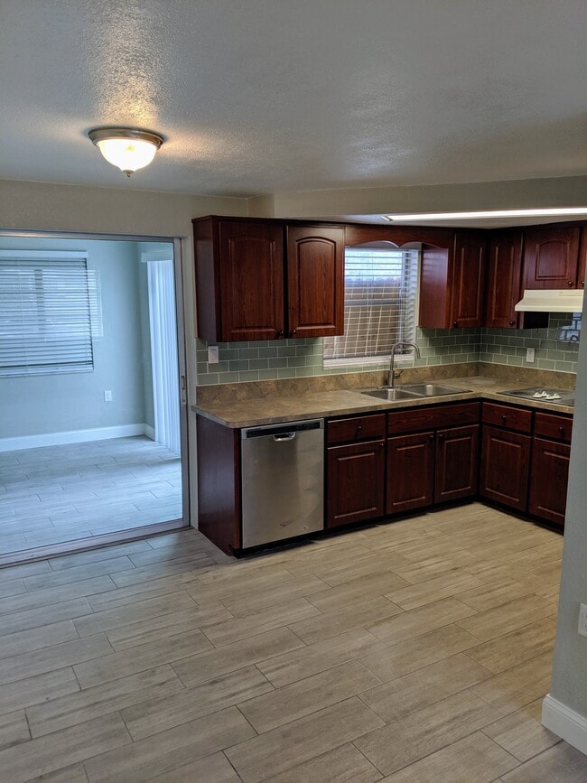Kitchen sink and dishwasher with view into dining area - 1147 Jennings Dr