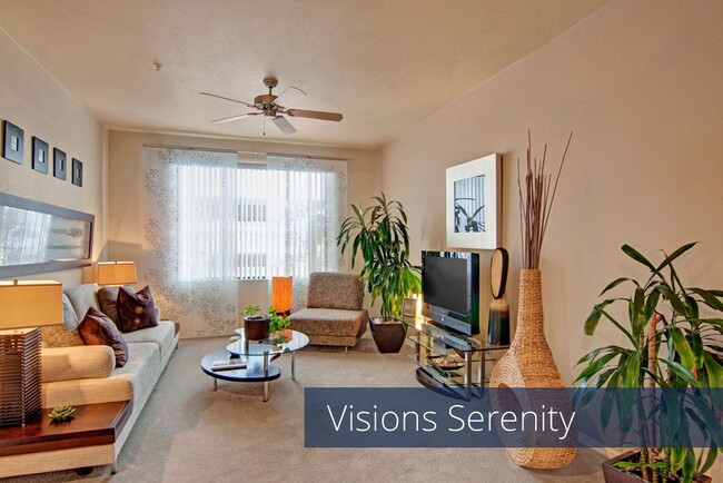 A living room with tall windows and a ceiling fan - Visions