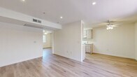Located at 730 N Whitnall Hwy in Burbank, CA, this one-bedroom, one-bathroom unit offers a thoughtfully laid-out single-floor plan. The living room greets you with recessed lighting, a ceiling fan, and a large window fitted with vertical blinds that allow natural light to fill the space. Light wood-style flooring runs consistently throughout, lending a clean and cohesive aesthetic to every room. The galley-style kitchen is efficiently organized with light wood cabinetry lining both sides, providing ample storage, along with a full suite of white appliances including a refrigerator, electric range, and dishwasher. The bedroom is a comfortable size, featuring a ceiling fan, two windows for natural light, and a full wall of mirrored sliding closet doors that add depth and brightness to the room. The bathroom is clean and functional, finished with matching wood-style flooring, a tub and shower combination with a curtain rod, and accessibility-friendly grab bars on the walls. Throughout the unit, the neutral white walls and consistent flooring create a bright, airy ambiance that offers a versatile canvas for personalization. This unit combines practicality with a clean, modern aesthetic in a well-situated Burbank location.
