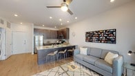 Located at 102 Logan Ct in Raleigh, NC, this modern single-floor unit offers a thoughtfully designed open-concept layout with contemporary finishes throughout. Light hardwood flooring flows through the main living areas, complementing the clean, neutral palette of the space.

The kitchen is a standout feature, equipped with rich dark-toned cabinetry, granite countertops, stainless steel appliances — including a refrigerator, microwave, and range — and a peninsula with bar seating that seamlessly connects to the living area. Recessed lighting illuminates the space, while a ceiling fan adds comfort overhead.

The living room is bright and inviting, with large windows allowing ample natural light and views of the surrounding neighborhood. The space comfortably accommodates both relaxing and entertaining.

Two bedrooms offer plush carpeting, ceiling fans, and windows that bring in natural light. The primary bedroom is generously sized with room for a sitting area, while the secondary bedroom is well-suited as a guest room or home office.

Two full bathrooms feature dark vanity cabinetry, white countertops, and hardwood-style flooring. A dedicated in-unit laundry area with a stacked washer and dryer adds everyday convenience. The overall design is clean, modern, and functional.