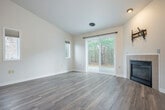 Located at 874 Xanadu Rd in Lake Delton, Wisconsin, this single-floor, one-bedroom, one-bathroom home offers a practical and comfortable layout. The living room serves as the centerpiece of the space, featuring light wood-look flooring, neutral walls, and a gas fireplace with a clean tile surround — an inviting focal point for relaxing evenings. Sliding glass doors flood the room with natural light and provide direct views of the surrounding wooded landscape, while an additional side window enhances the bright, airy atmosphere. The kitchen is efficiently designed with warm honey-toned wood cabinetry, white tile backsplash, light countertops, and black appliances including a full-size refrigerator and dishwasher. The bedroom offers comfortable carpeted flooring, a ceiling fan, a natural light window, and a double-door closet, providing practical storage. The full bathroom is outfitted with wood-toned vanity cabinetry, a tub-shower combination, and light wood-look flooring, maintaining a clean and cohesive aesthetic. Throughout the home, consistent light tones and updated finishes create a move-in-ready environment suited for comfortable, everyday living in the heart of Wisconsin Dells country.