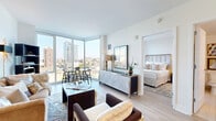 Located in Milwaukee's vibrant downtown, this thoughtfully designed one-bedroom, one-bathroom residence offers a seamless blend of modern style and urban convenience. The open-concept kitchen and living area serves as the heart of the home, featuring light hardwood flooring throughout, crisp white walls, and an abundance of natural light. Floor-to-ceiling corner windows frame sweeping views of the Milwaukee skyline, creating a bright and airy atmosphere in both the living and dining areas.

The well-appointed kitchen is outfitted with dark cabinetry, stainless steel appliances including a gas range, microwave, and refrigerator, complemented by light quartz countertops and a subway tile backsplash. A peninsula with bar seating connects the kitchen to the living space effortlessly.

The private bedroom benefits from its own floor-to-ceiling window with continued city views, offering a serene and luminous retreat. The bathroom features light tile flooring, a glass-enclosed shower, and clean, contemporary finishes. Additional highlights include a dedicated closet, a laundry area with in-unit washer and dryer, and a welcoming entrance. This residence delivers a polished, upscale urban living experience in the heart of Milwaukee.