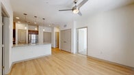 Located at 7515 Holm Rd in San Antonio, TX, this single-floor, 2-bedroom, 3-bathroom residence offers a practical and modern living experience. The open-concept living and dining area is finished with light wood-look flooring and a ceiling fan, creating a bright and airy atmosphere. Natural light flows in through multiple windows fitted with blinds, and a set of glass doors leads to a private balcony.

The kitchen is a standout feature, boasting granite countertops, a peninsula with an undermount sink, rich dark-wood cabinetry, pendant lighting, and a full suite of stainless steel appliances including a refrigerator, range, microwave, and dishwasher. A pantry provides additional storage. The kitchen opens seamlessly to the living area, making it ideal for entertaining.

Both bedrooms are carpeted and include ceiling fans and ample natural light. The primary bedroom connects to a well-designed en-suite bathroom with granite counters, dark cabinetry, light wood flooring, and a tub with white tile surround. Multiple closets — including a walk-in with wire shelving — provide generous storage throughout. A dedicated laundry area and hallway complete the thoughtfully arranged floor plan.